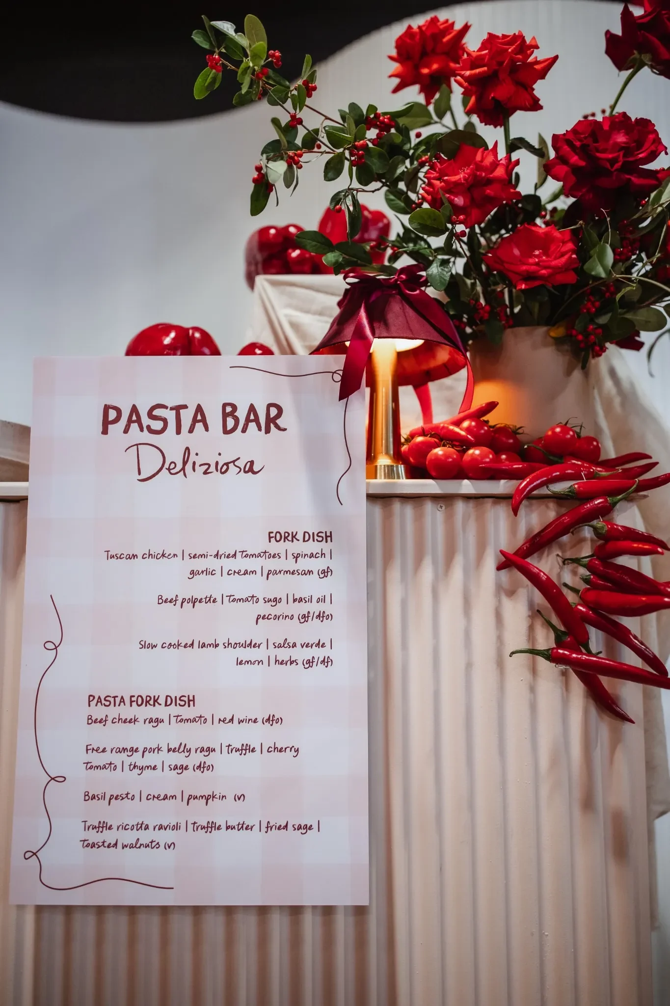Pasta bar with floral and vegetable sculptural styling