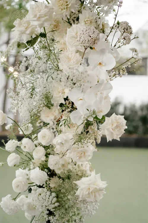Close-up of white wedding flowers including roses and orchids styled for a Refinery Brisbane ceremon