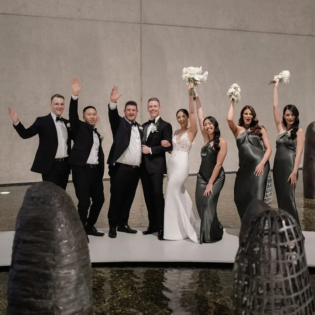 Bridal party celebrating at Brisbane wedding reception at QUAGOMA.