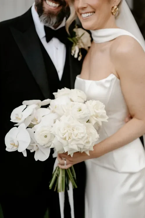 White bridal bouquet with roses and orchids designed for a Refinery Brisbane wedding