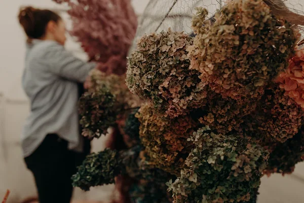 Close-up of textured dried hydrangea and foliage used in the West Village corporate floral installation.