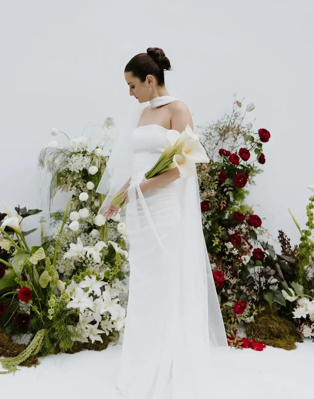 Modern Sculptural wedding ceremony floral art with Brisbane bride holding arum lilies
