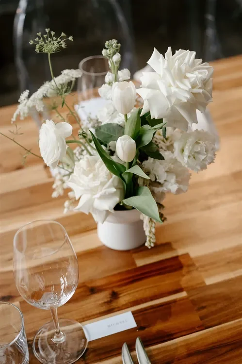 Low white floral centrepiece with seasonal blooms for a Refinery Brisbane wedding reception