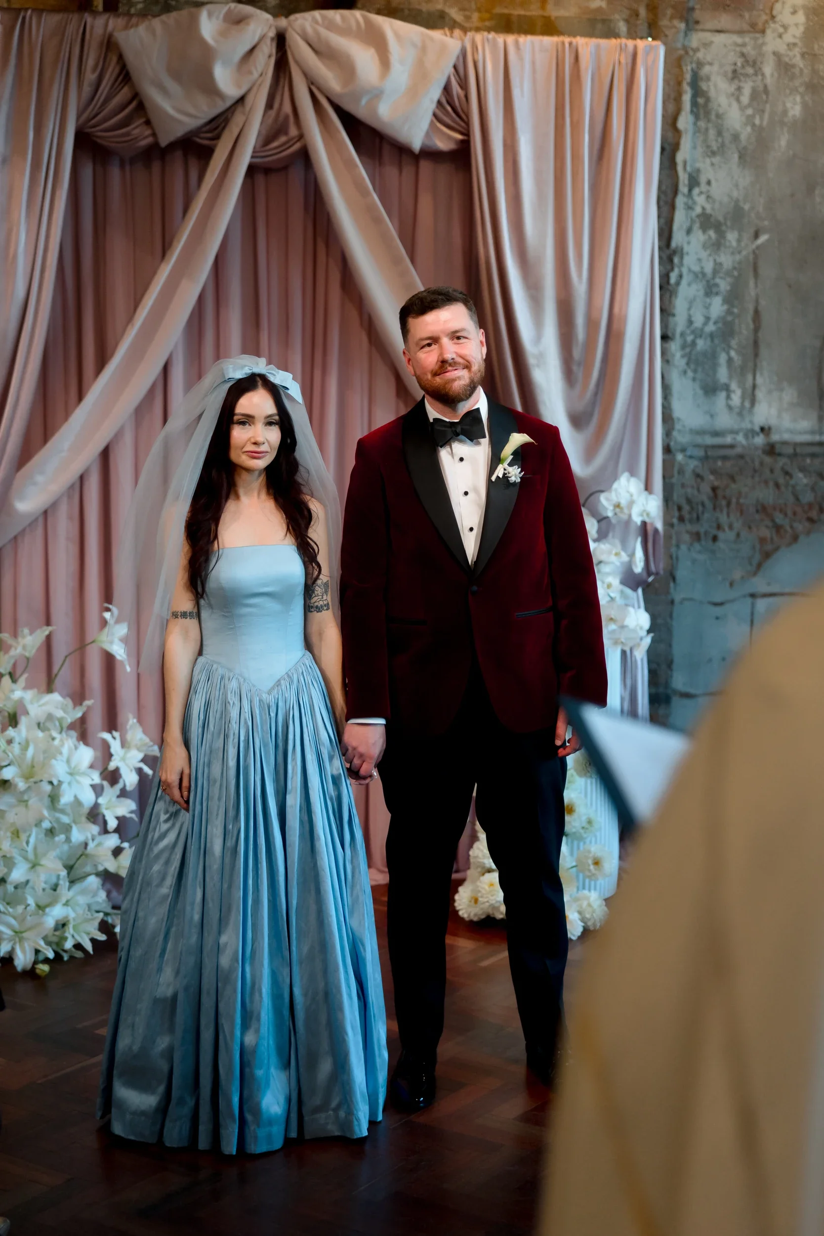 Bride in a powder blue gown and groom at the blush draped ceremony