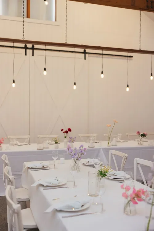 Minimal wedding table styling with delicate Garden Graffiti bud vase florals and white linen