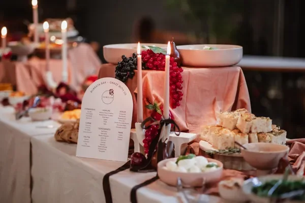 Italian-themed burrata bar display styled with fresh grapes, focaccia, candles and Sorella event signage at a Brisbane event.