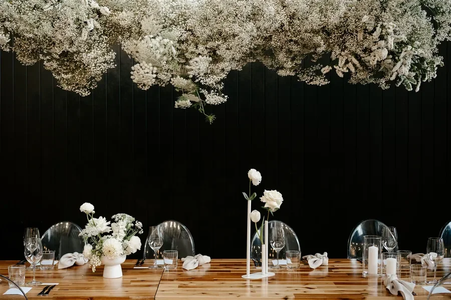 Dramatic hanging white floral installation above reception tables at The Refinery Brisbane