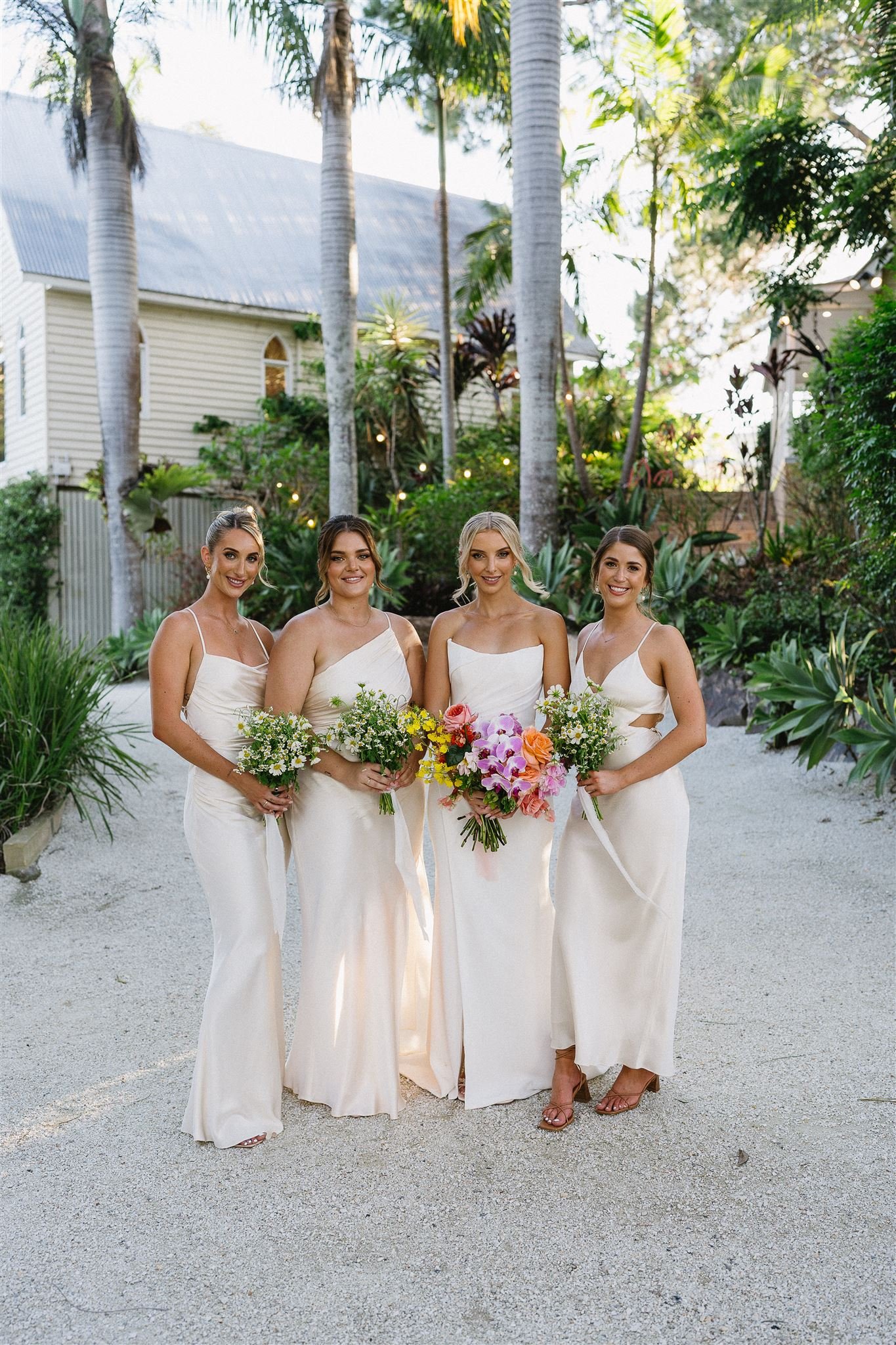 bride and bridesmaids holding floral bouquets at gold coast wedding venue