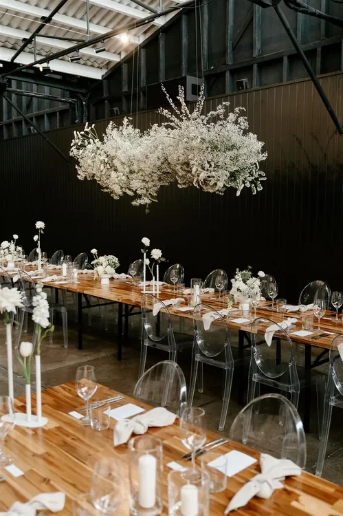 Dramatic hanging white floral installation above reception tables at The Refinery Brisbane