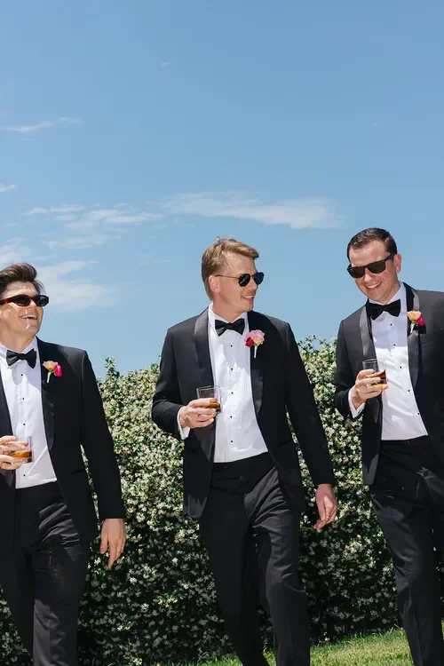 Wedding welcome sign framed with colourful Garden Graffiti floral arrangements inside a bright chapel