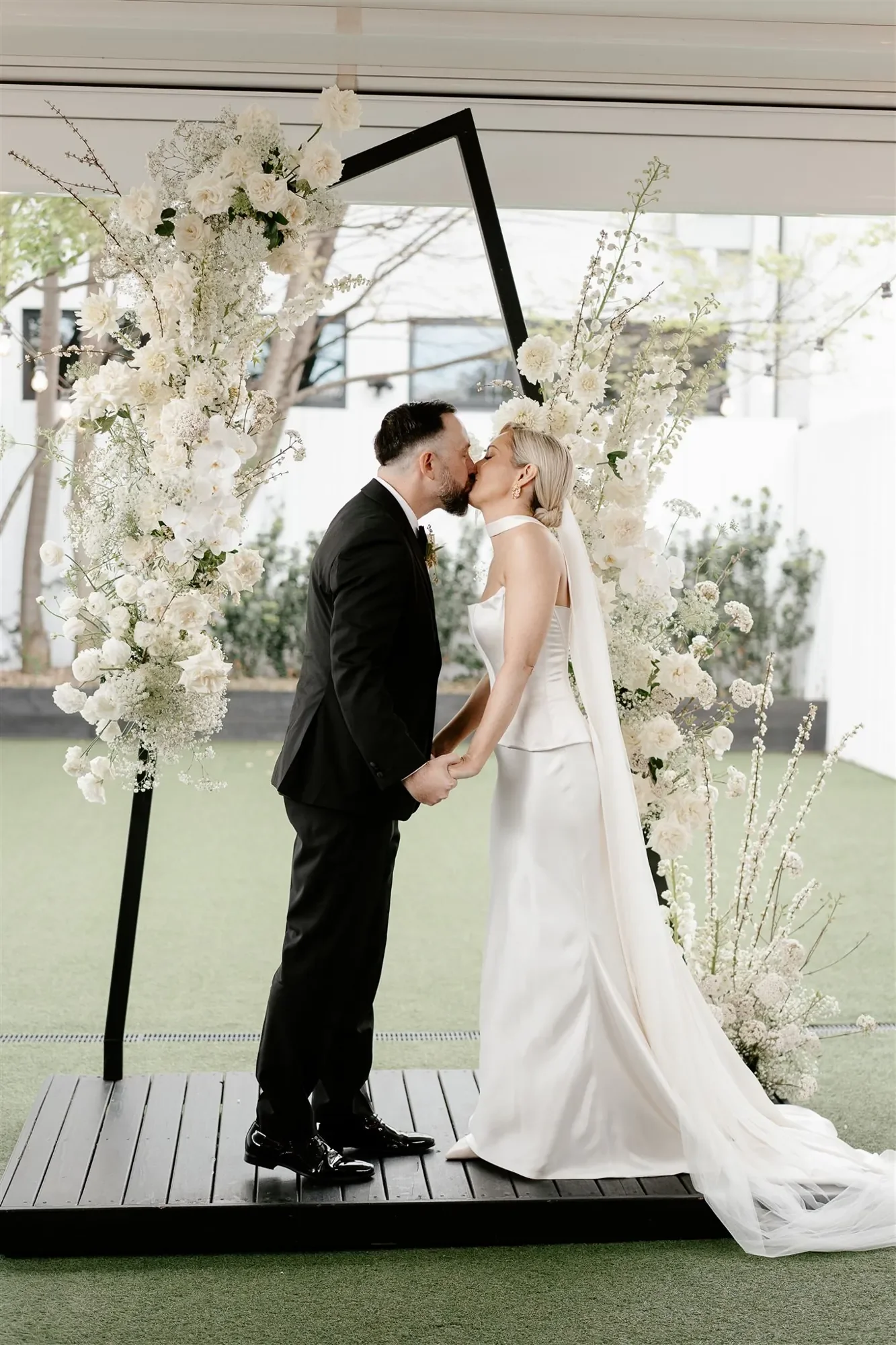 Brisbane Wedding arbour with newlywed couple white flowers