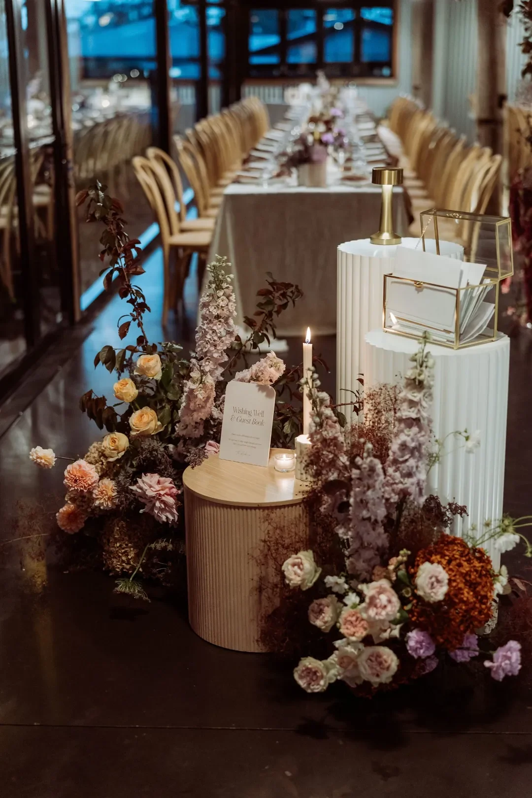Romantic reception display featuring the wishing well and guest book, styled with candles and lush pastel floral arrangements at Annalise and Mitchell’s wedding.