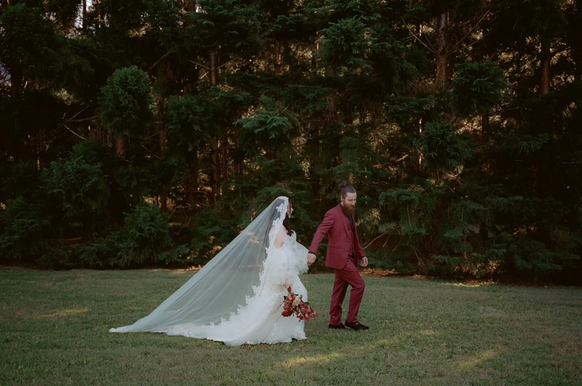 bride and groom at moody wedding with bridal bouquet The Bower Estate