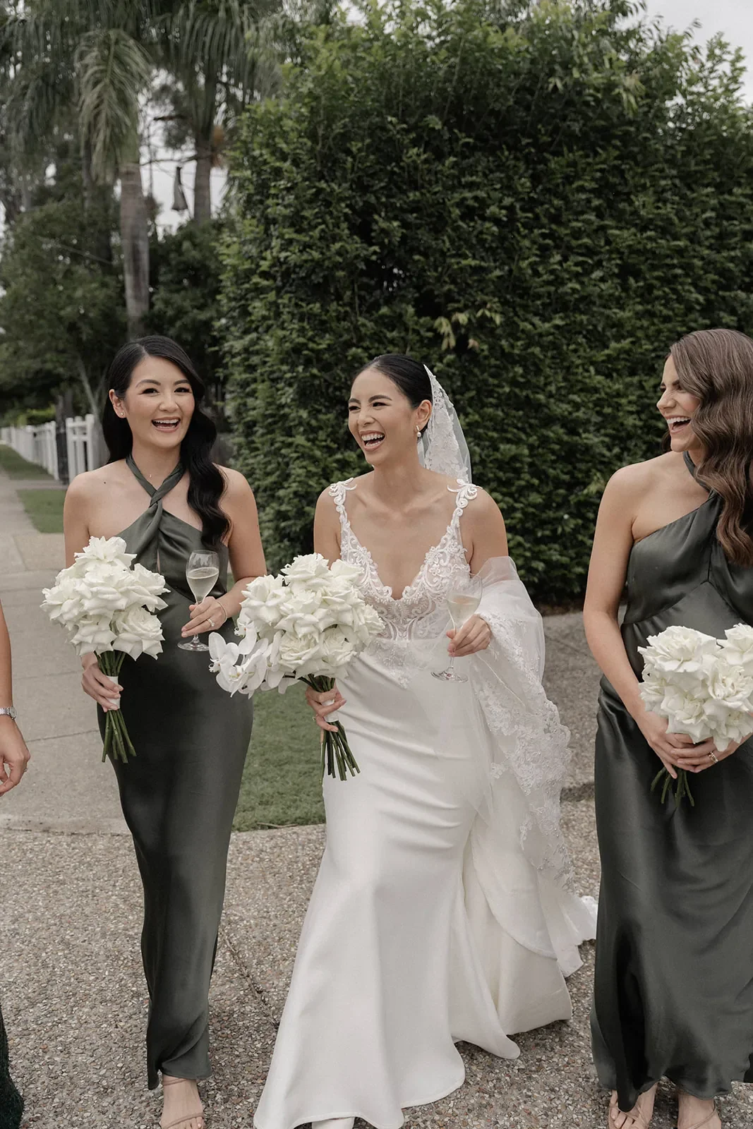 bride and bridesmaids with white rose bouquets at Brisbane Wedding venue.