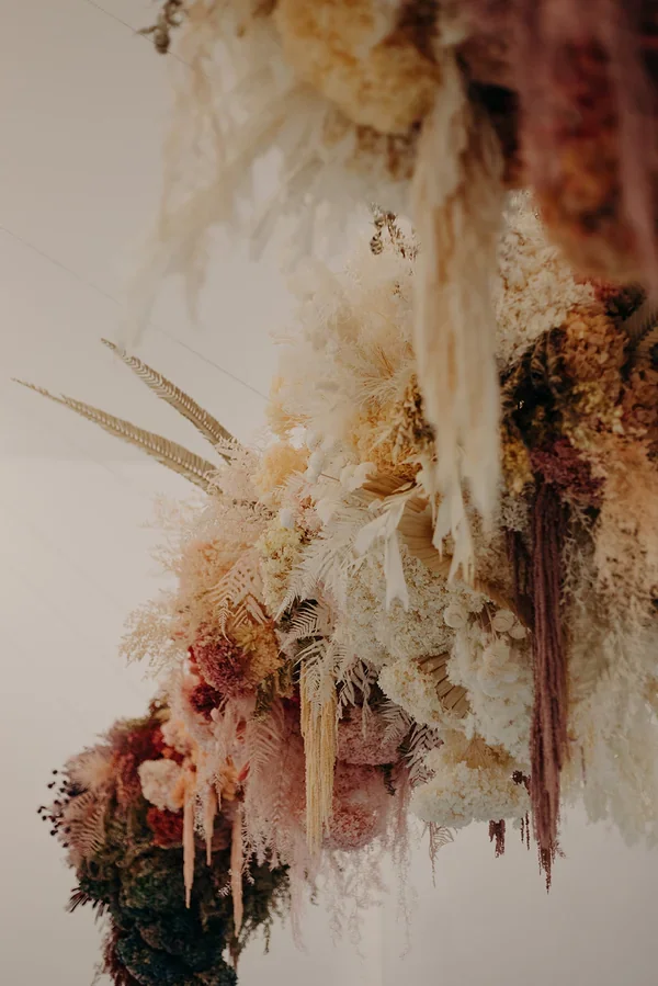 Garden Graffiti florist selecting and arranging dried flowers during construction of the floral artwork at West Village.