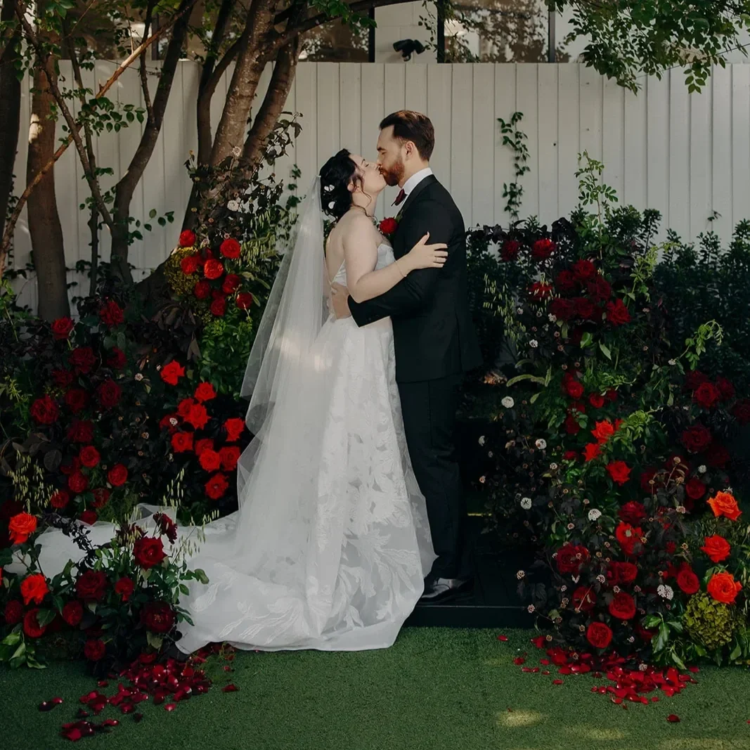 romantic moody floral arbour with newlywed couple during ceremony in Brisbane