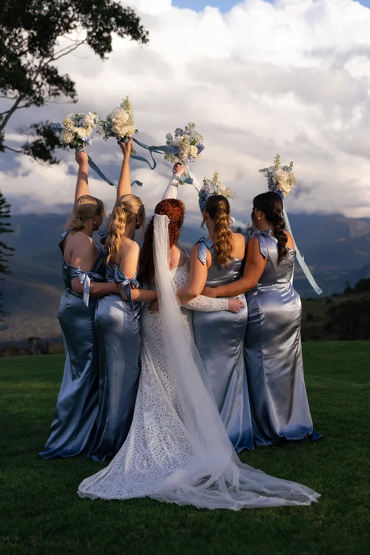 bride and bridesmaids in blue dresses Brisbane Wedding Florist