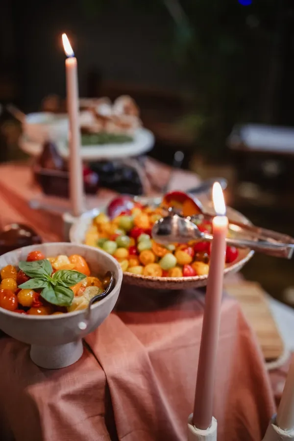 Styled Italian grazing table with fresh mozzarella, tomatoes, bread and candlelit décor for a Brisbane event.