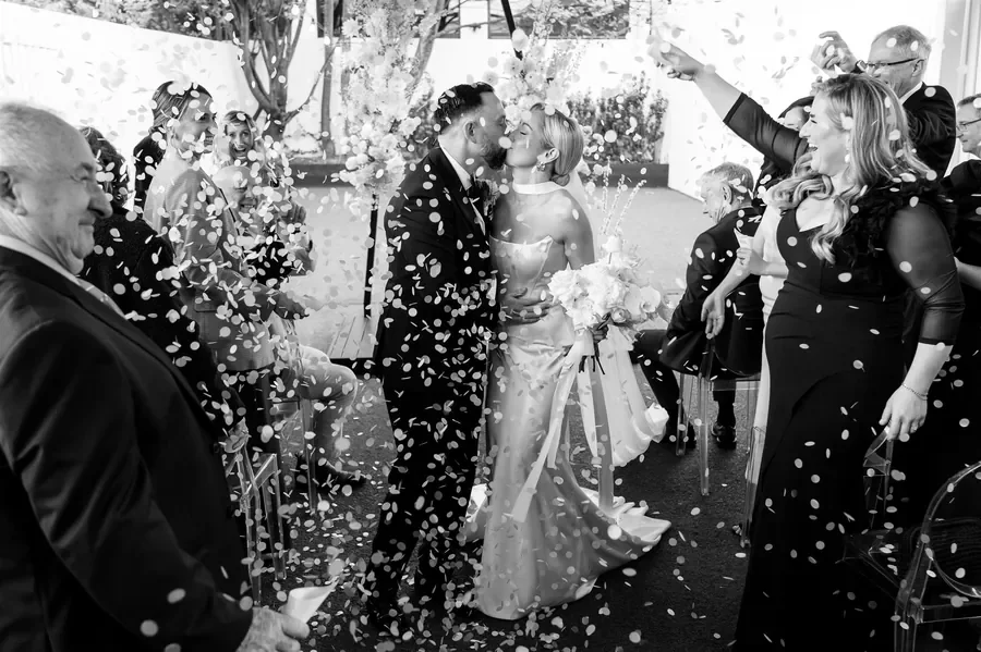 Wedding ceremony exit with confetti and white floral installations at The Refinery Brisbane