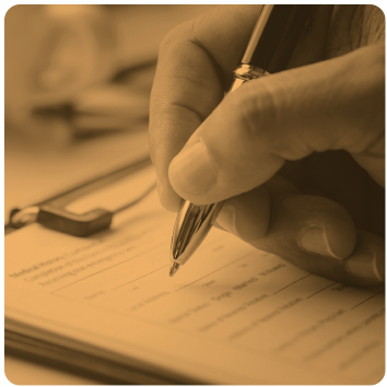 Close-up of a hand writing on a clipboard with a pen