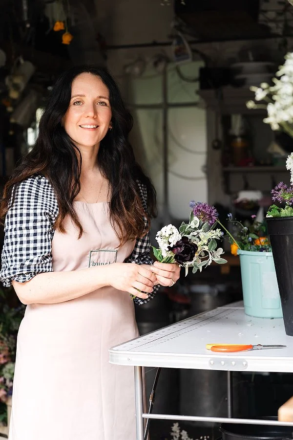 Melissa, florist at Bunch, holds a posy of spring flowers and explains why she loves eco friendly funeral flowers.