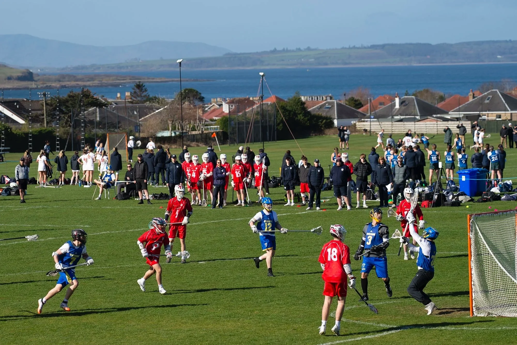 England match ongoing with houses and sea behind