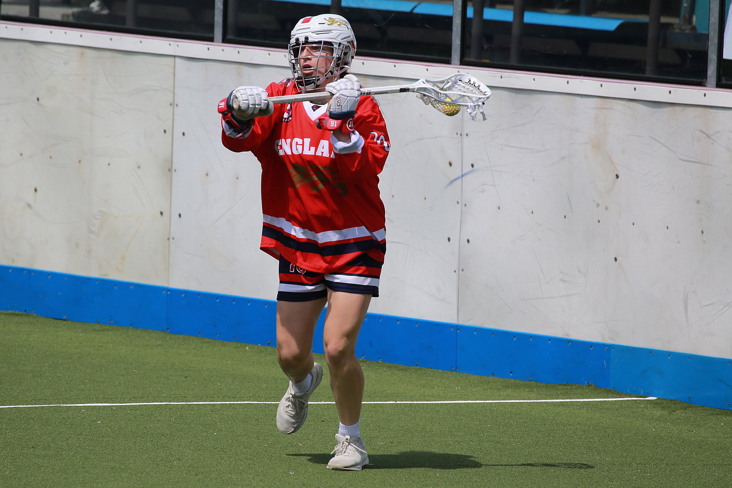 England player with ball in stick against Germany