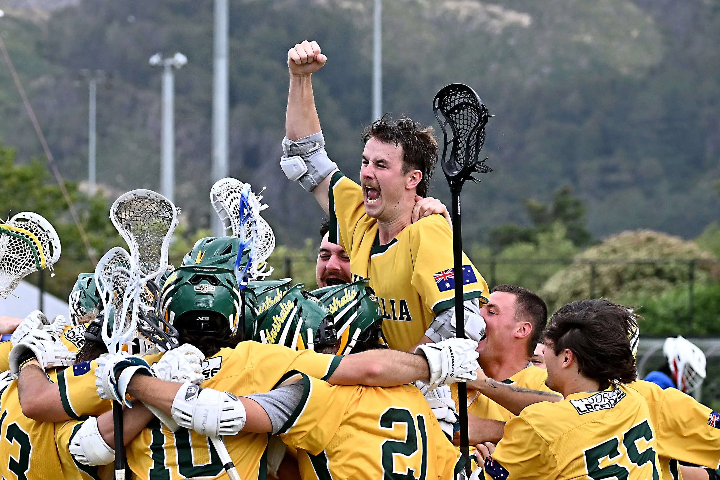 Australia players celebrate with one player screaming with arm in air