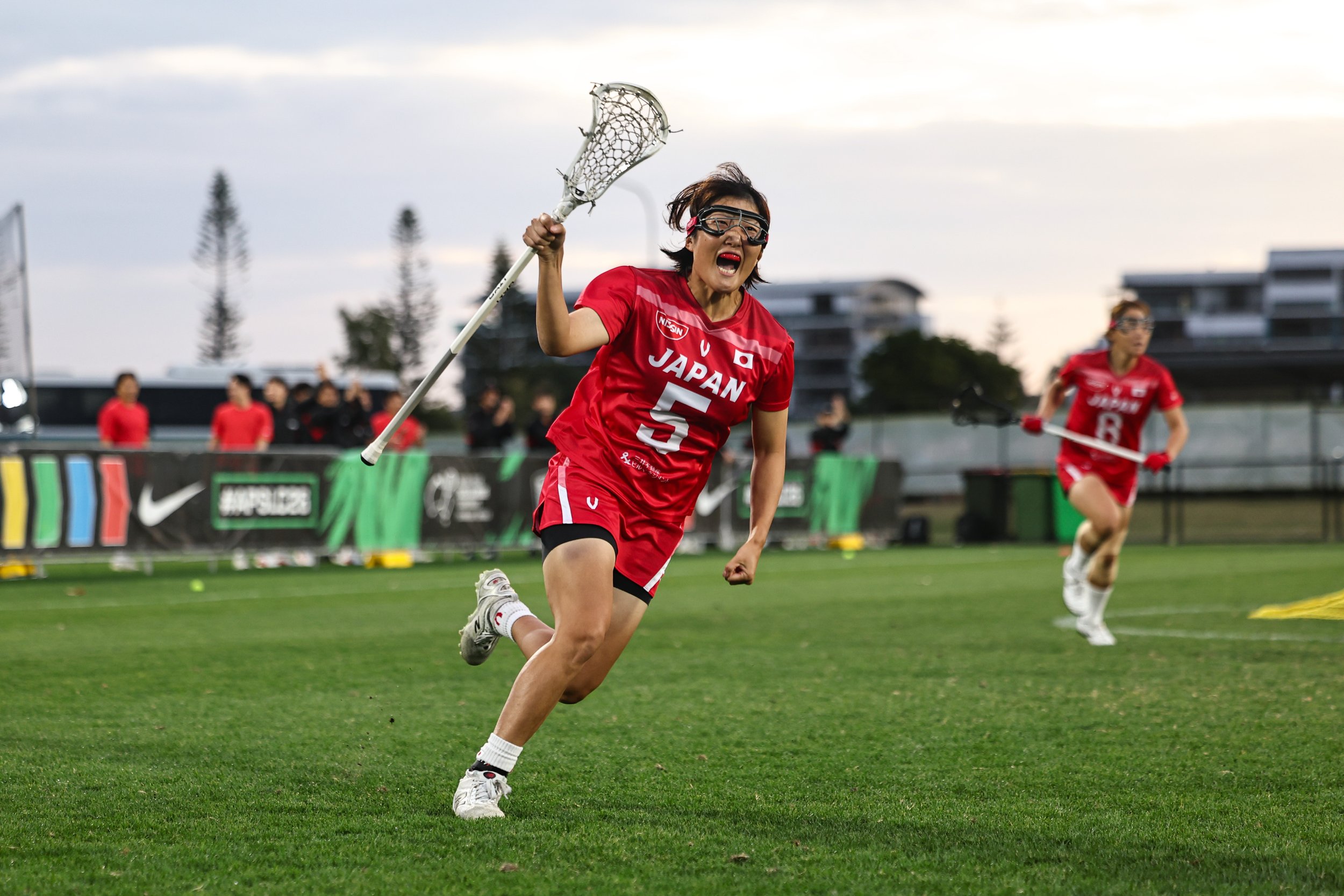 Japan player reels away, celebrating a goal