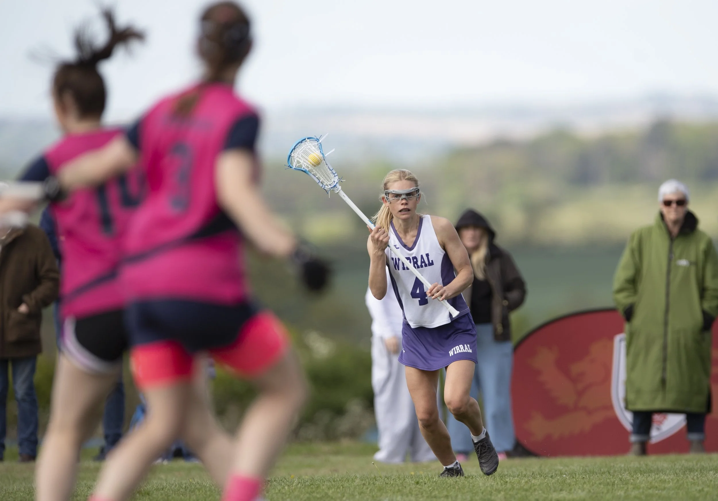 Lacrosse player with ballmin stick