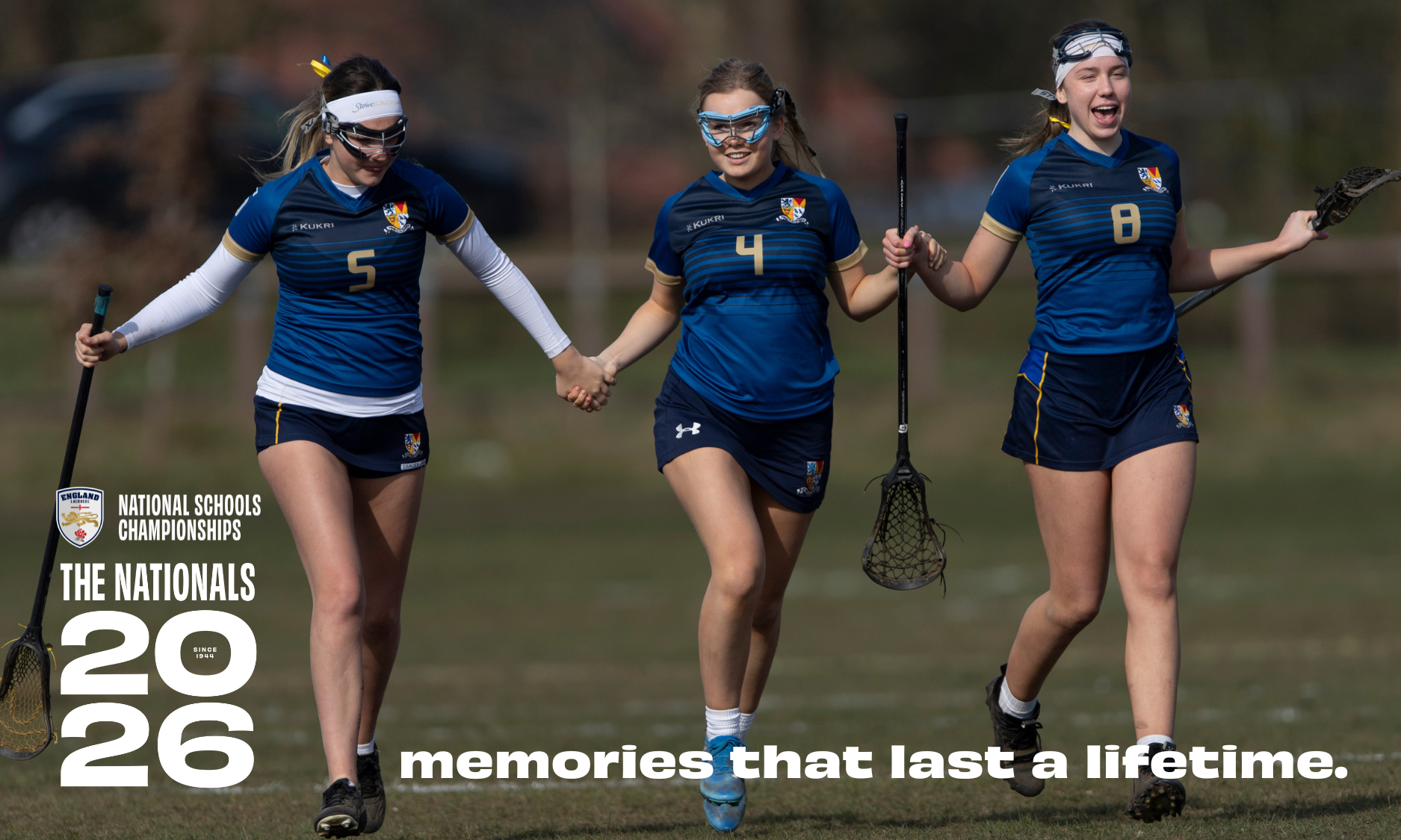 Three players hold hands and run together at the National Schools Lacrosse Championships