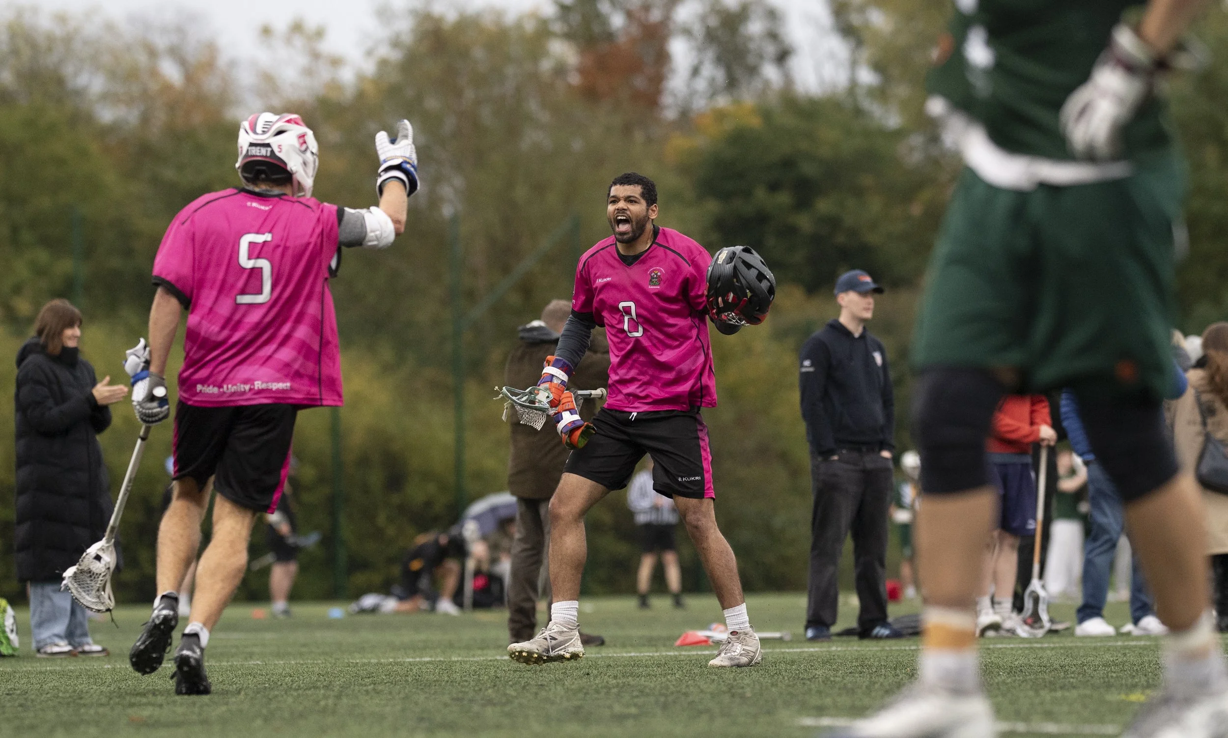 University player celebrates with helmet in hand
