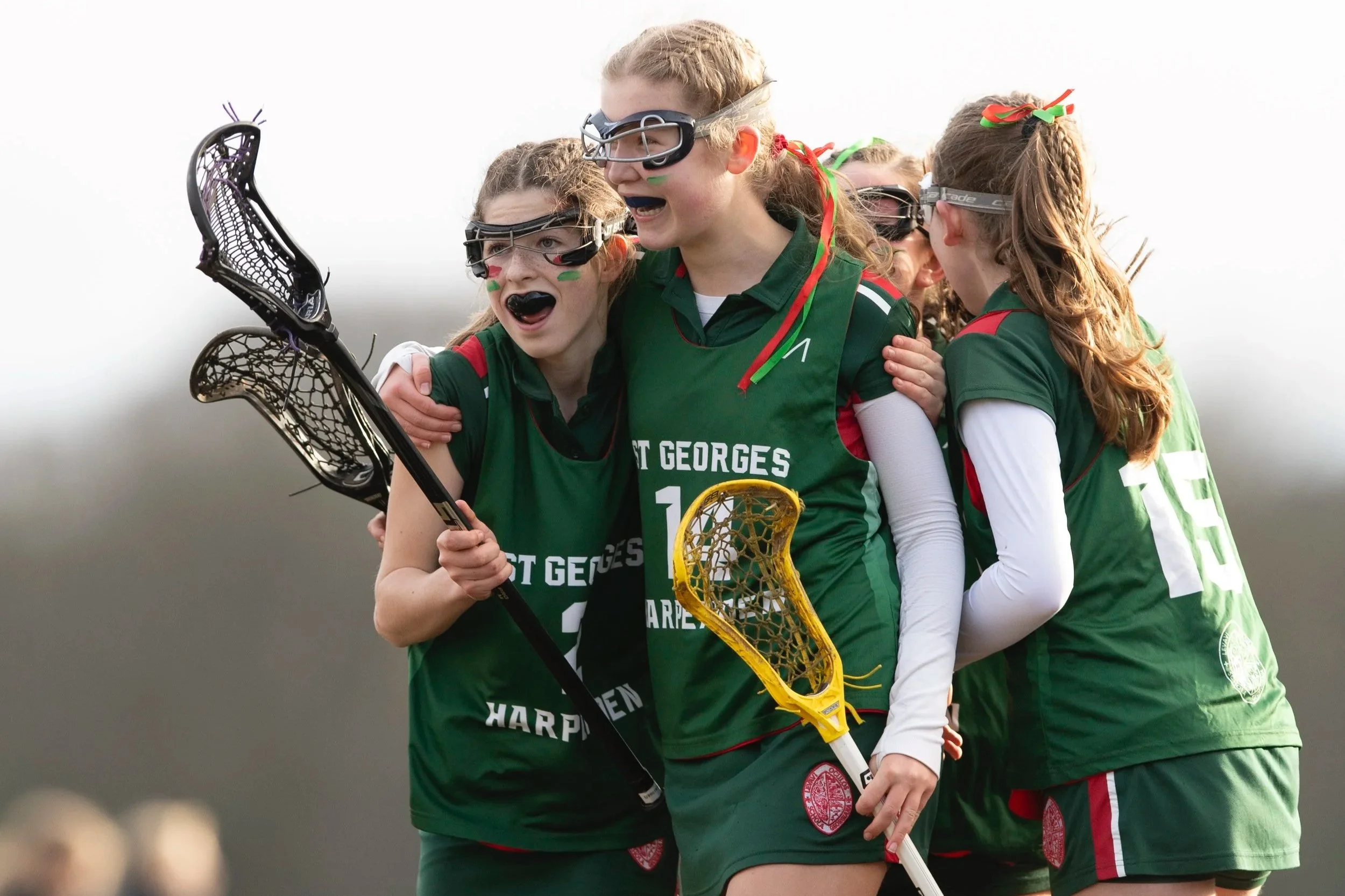 St George's players celebrate with each other after a goal