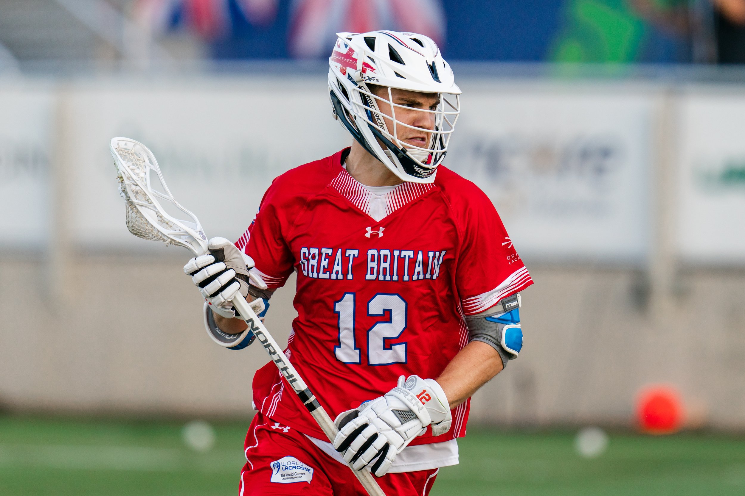 Tommy Kirkland with ball in stick running towards camera at The World Games 2022