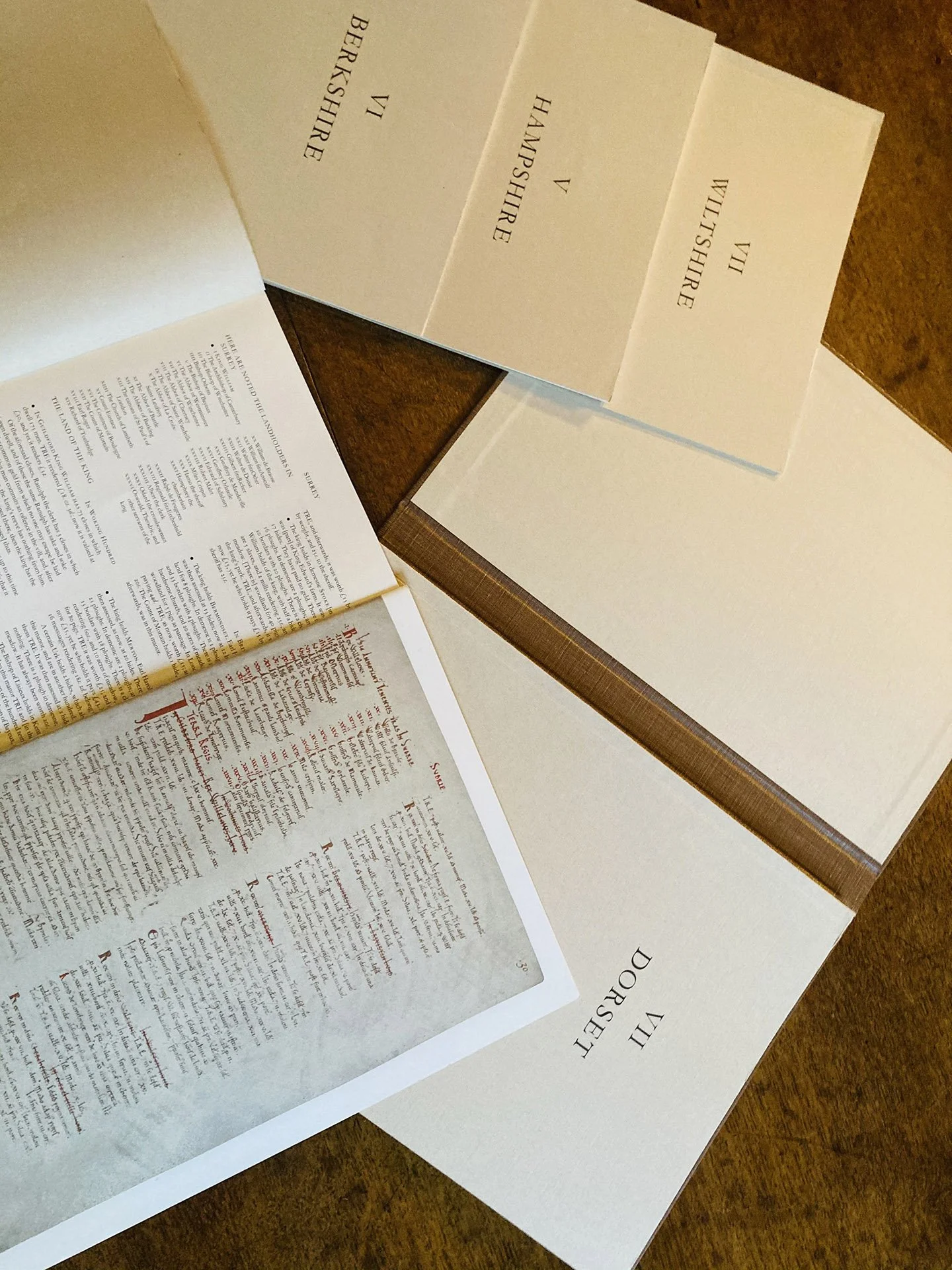 Open book pages displaying text and headings of English counties: Berkshire, Hampshire, Wiltshire, Dorset. Historical manuscript visible.