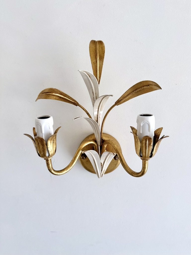 Detail of an aged gilt-metal flower cup surrounding the white E14 socket on a vintage Italian tole sconce.