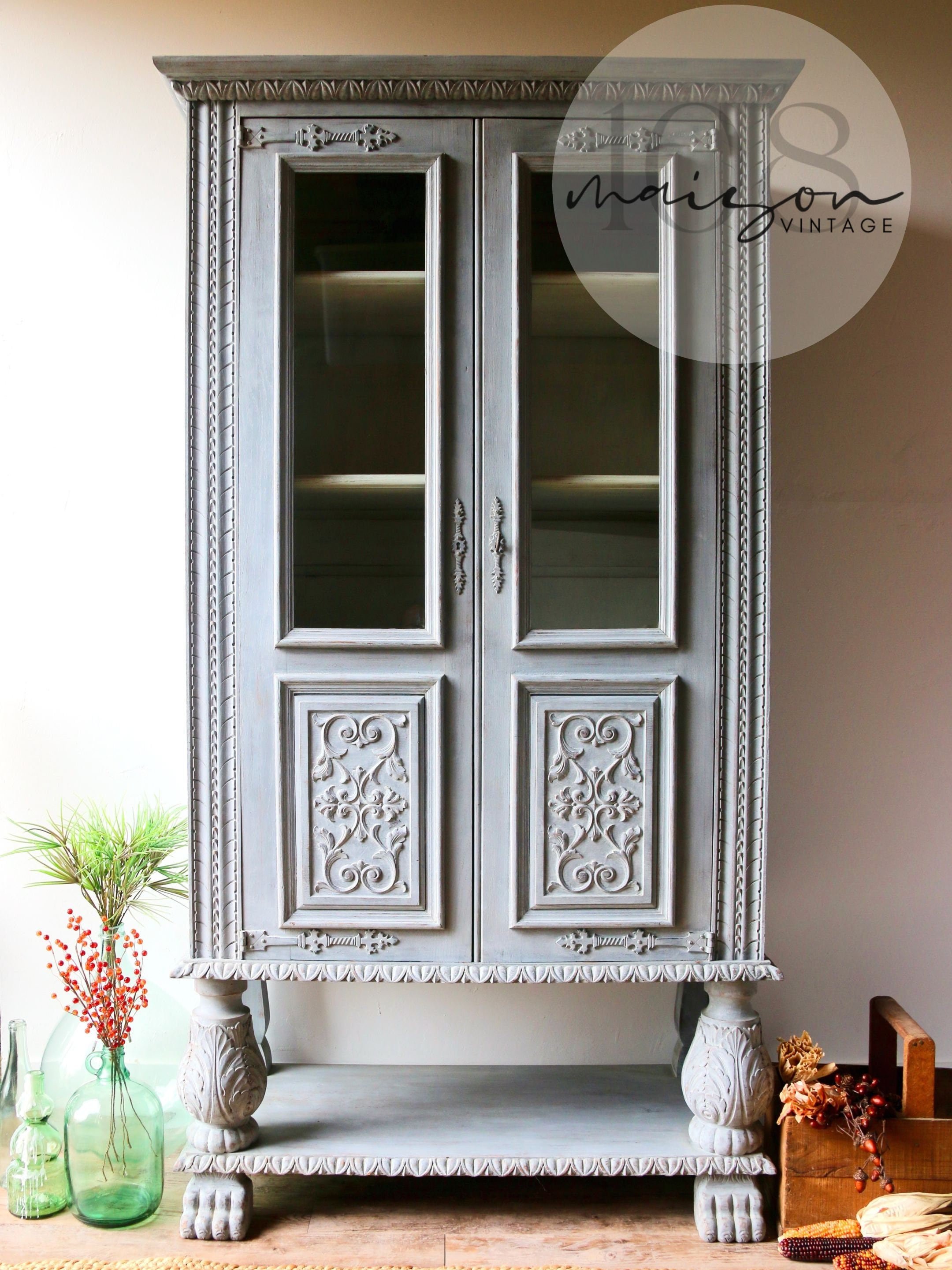 Solid wood 2 door hutch/cabinet with intricate carvings hand-painted in light gray with ivory interior. Vintage French Bibliothèque 1960s