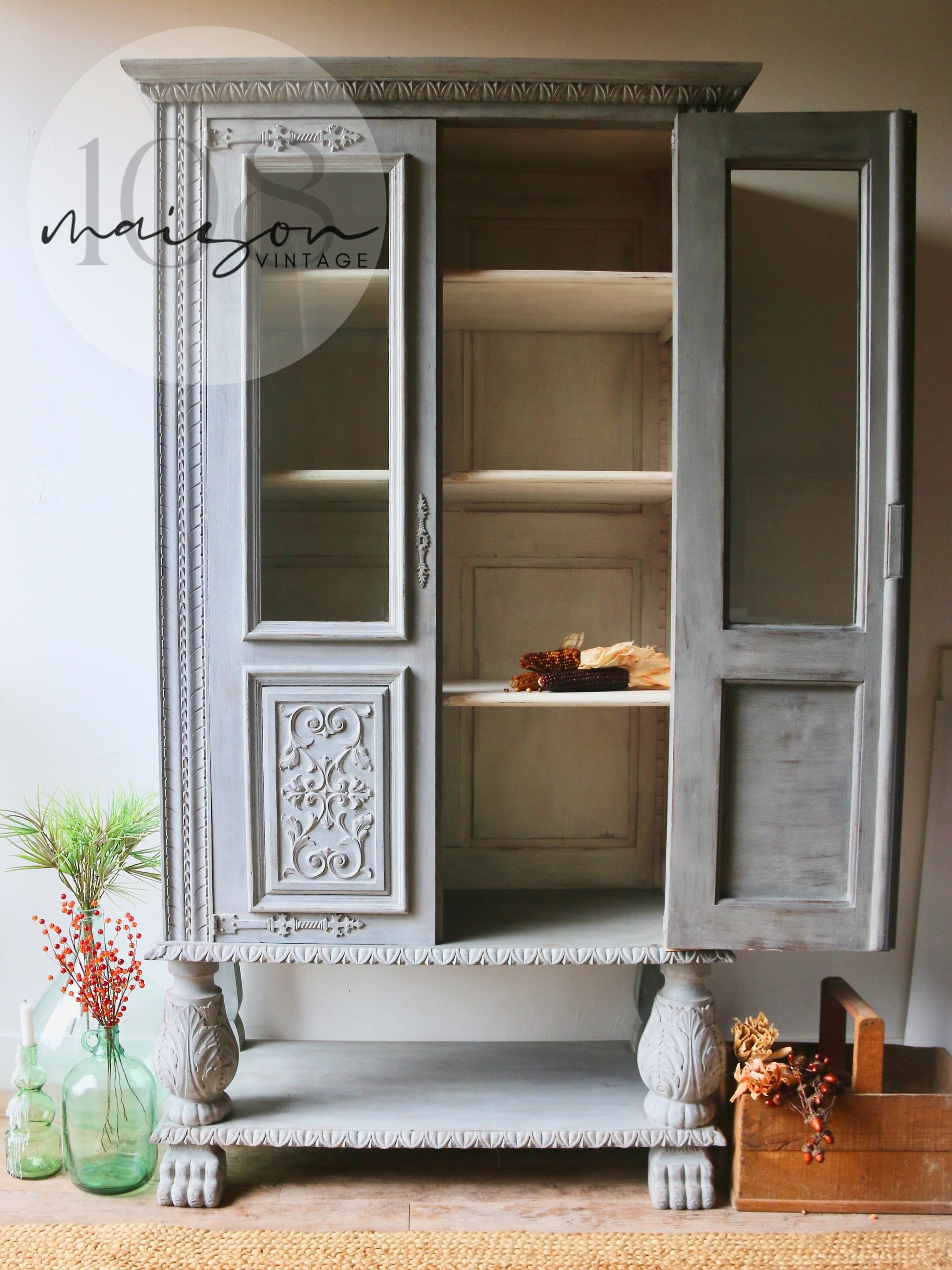 Solid wood 2 door hutch/cabinet with intricate carvings hand-painted in light gray with ivory interior. Vintage French Bibliothèque 1960s