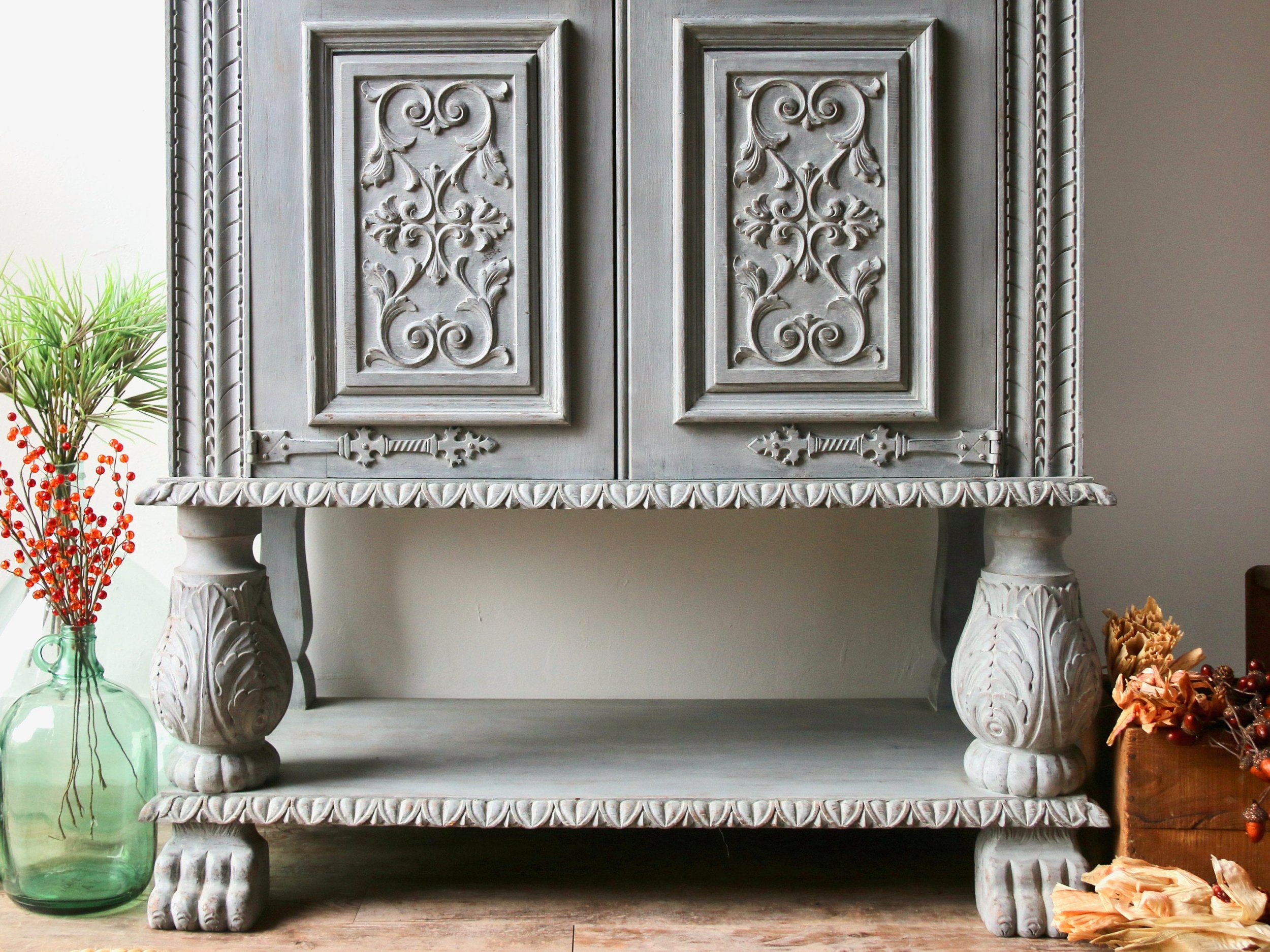 Solid wood 2 door hutch/cabinet with intricate carvings hand-painted in light gray with ivory interior. Vintage French Bibliothèque 1960s
