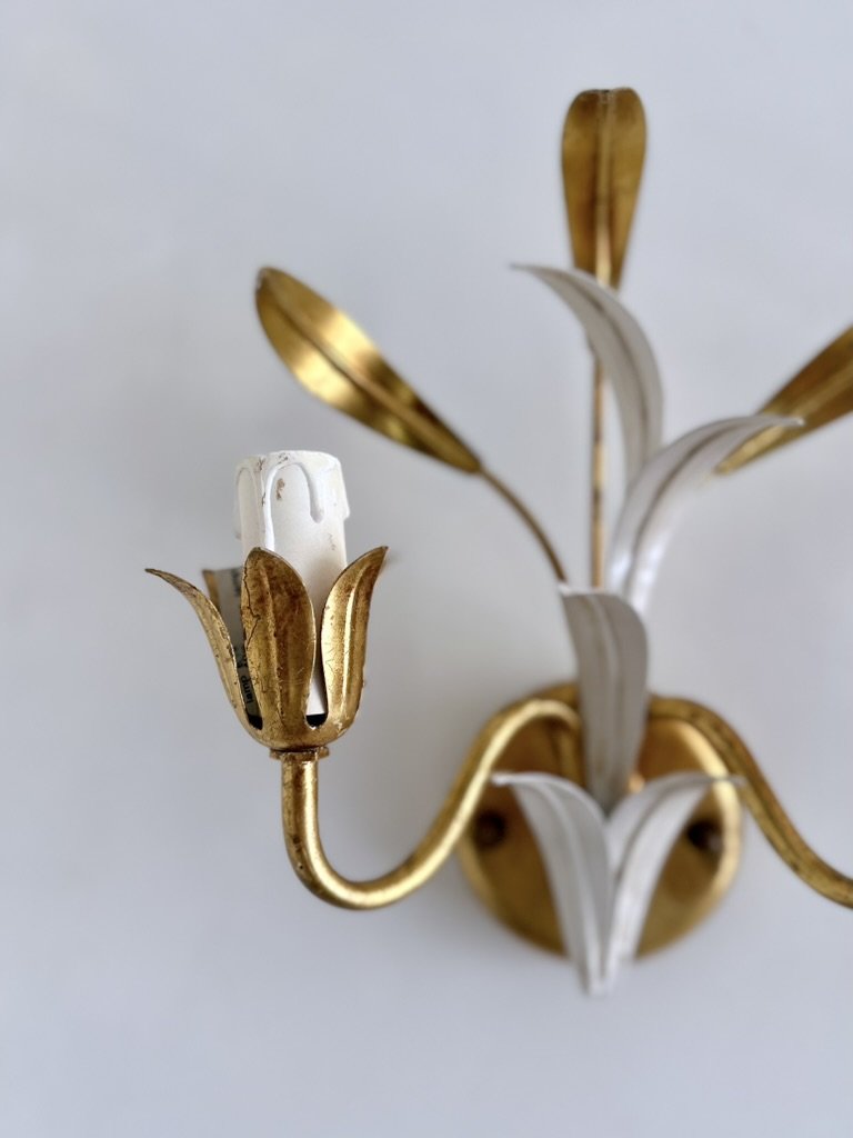 Detail of an aged gilt-metal flower cup surrounding the white E14 socket on a vintage Italian tole sconce.