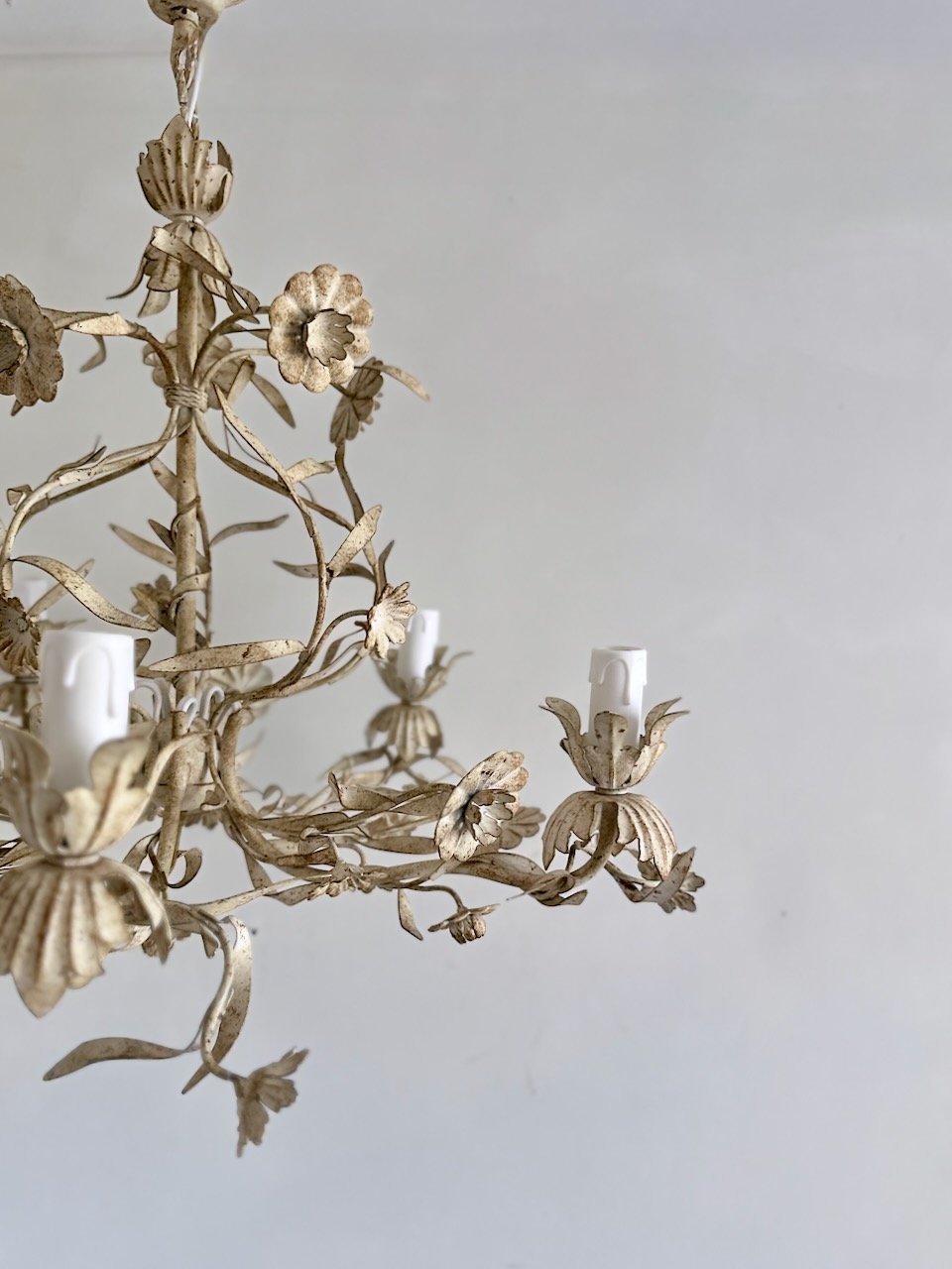 Side detail of vintage five-light flower chandelier with curling metal vines, botanical leaves and cream antiqued finish..jpeg