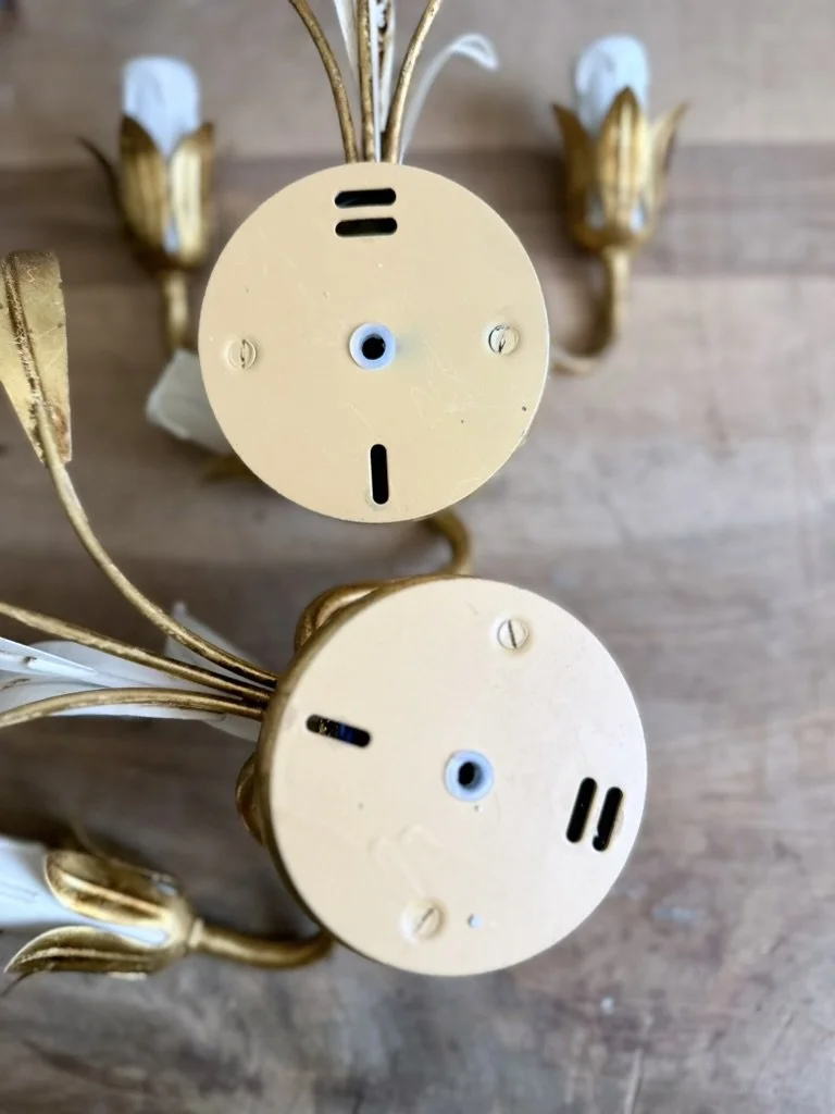 Rear view of the round metal mounting plate on a 1970s Italian hardwired wall light attributed to Masca.