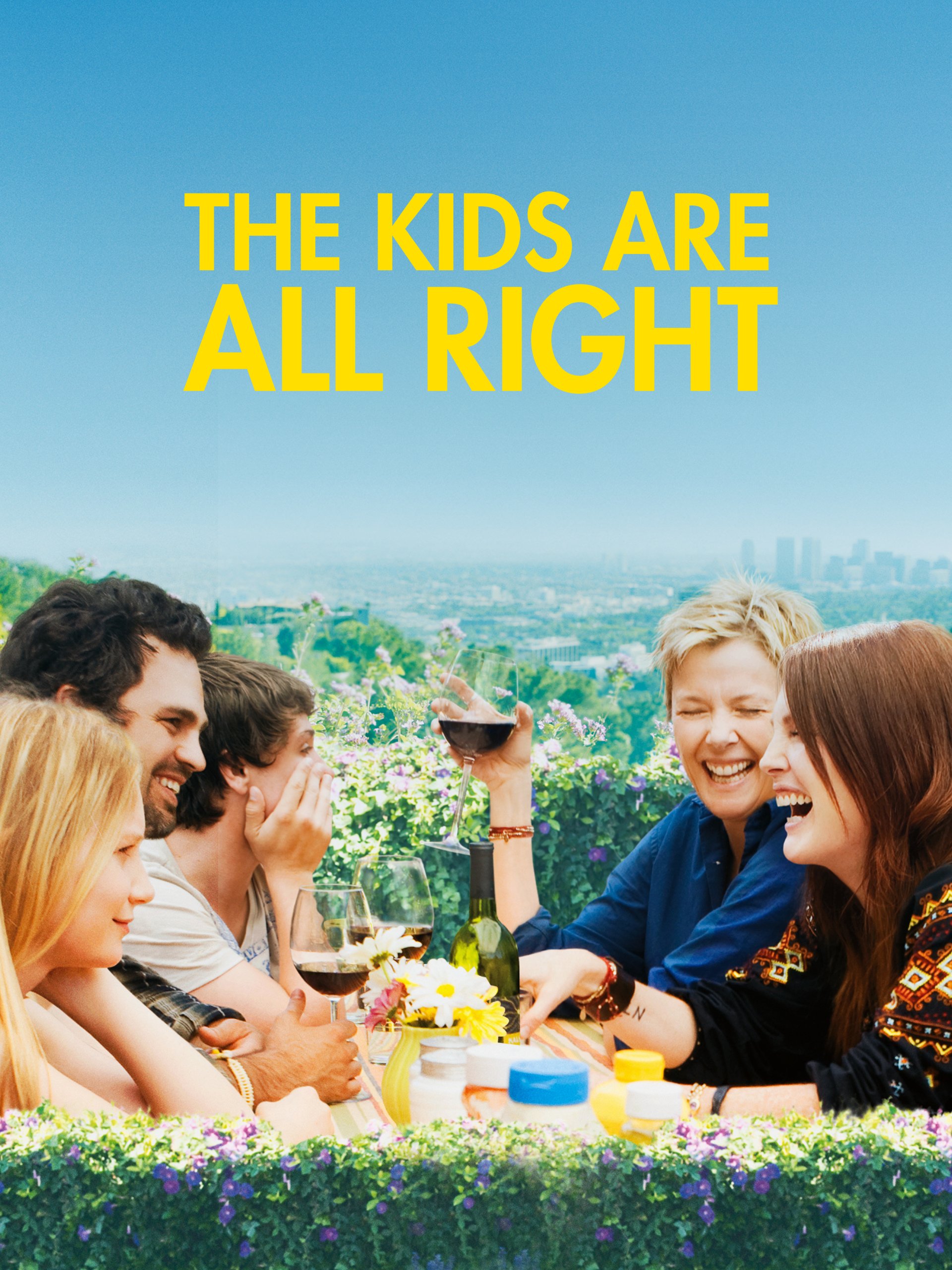 Group of people sitting outdoors at a table, holding wine glasses and laughing, with the text 'The Kids Are All Right' above them.