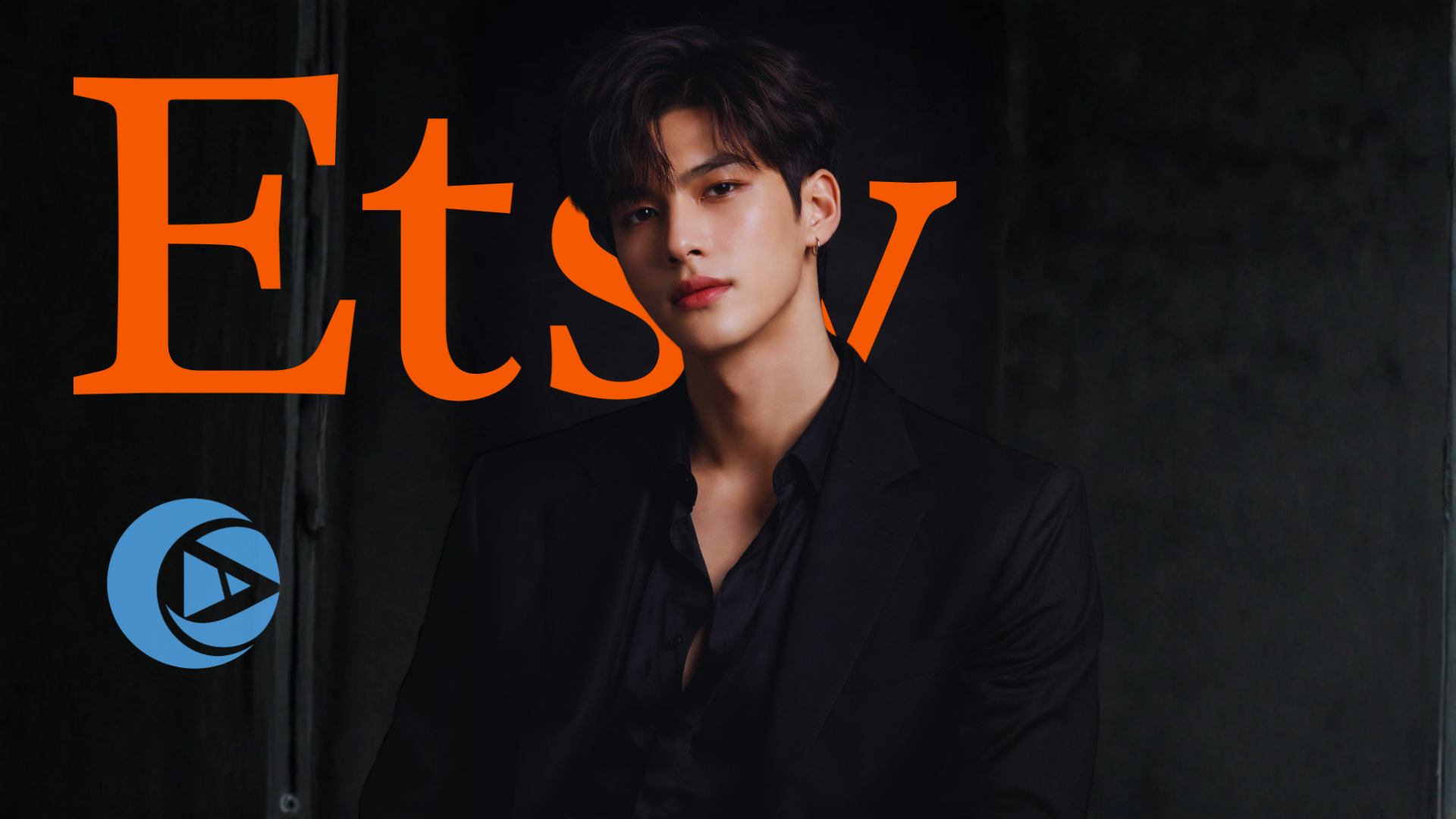 A young man with dark hair and earrings wearing a black suit and shirt, standing against a dark background with the large orange letters 'Etsy' and a small, partially visible blue logo.