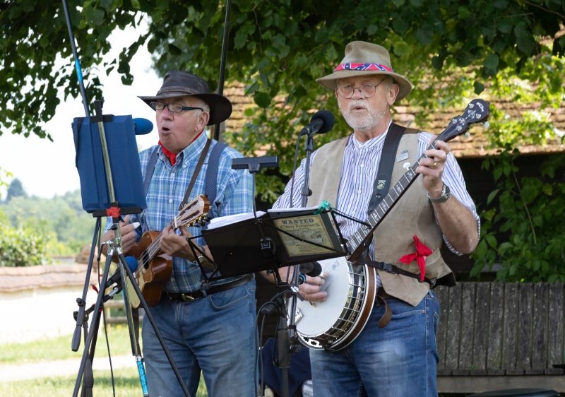 Two musicians playing instruments and singing