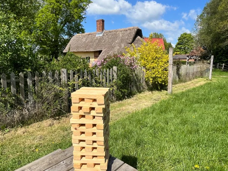 jenga infront of yellow cottage