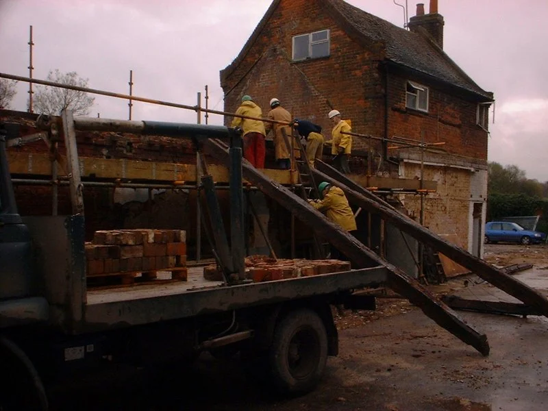 men working on half-dismantled building
