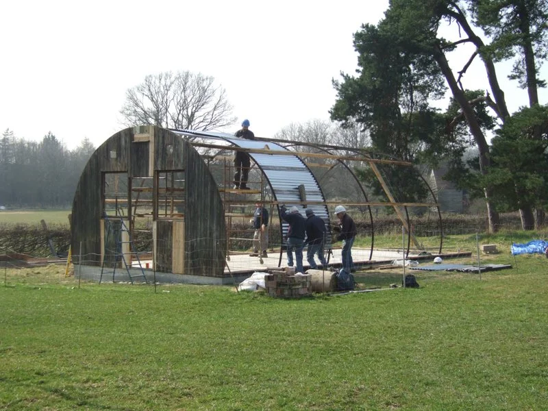 walls to corrugated iron building being put up 