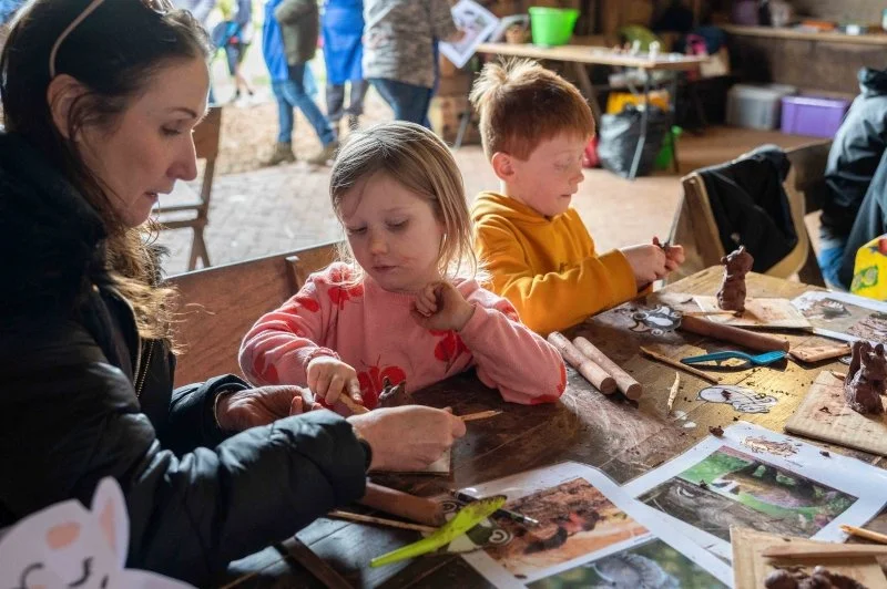 Children making small statues out of clay