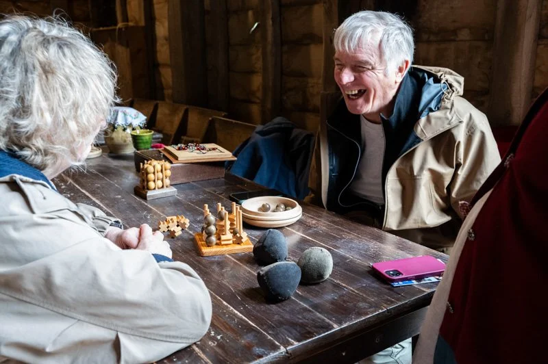 man and woman playing old board game
